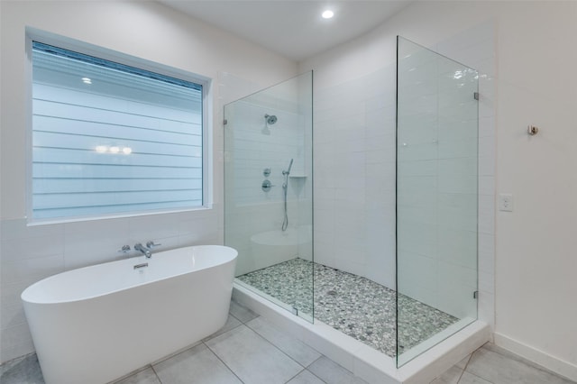 bathroom featuring tile patterned floors and independent shower and bath