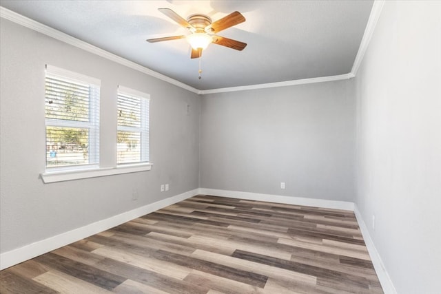 empty room featuring crown molding, dark hardwood / wood-style floors, and ceiling fan