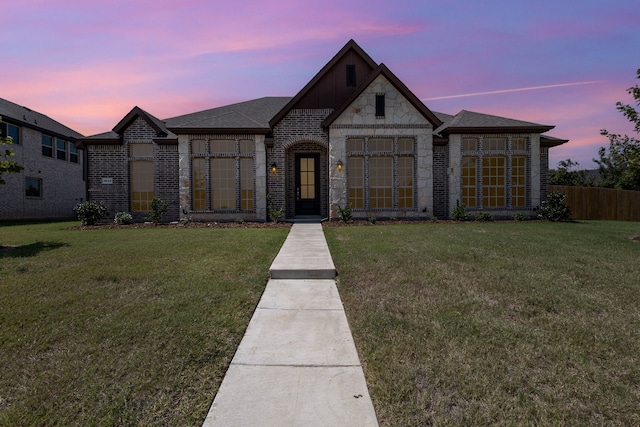 french country style house with a yard