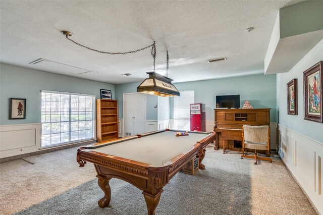 recreation room featuring a textured ceiling, billiards, and light colored carpet