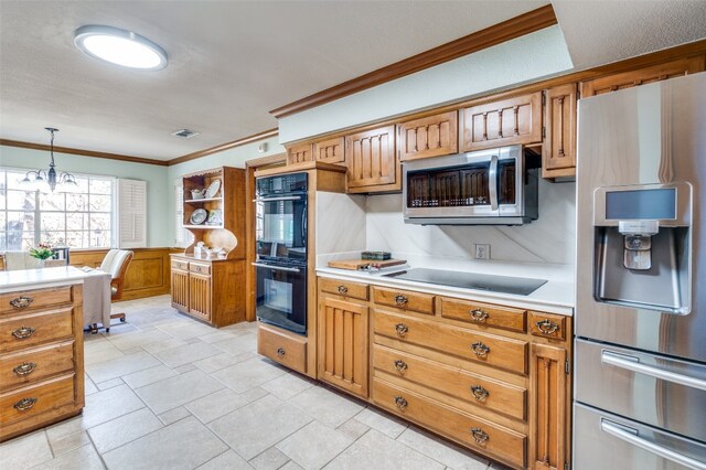 kitchen featuring a notable chandelier, black appliances, light tile flooring, and pendant lighting