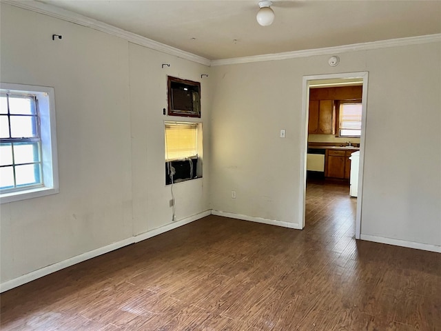 unfurnished room with dark hardwood / wood-style flooring, crown molding, and sink