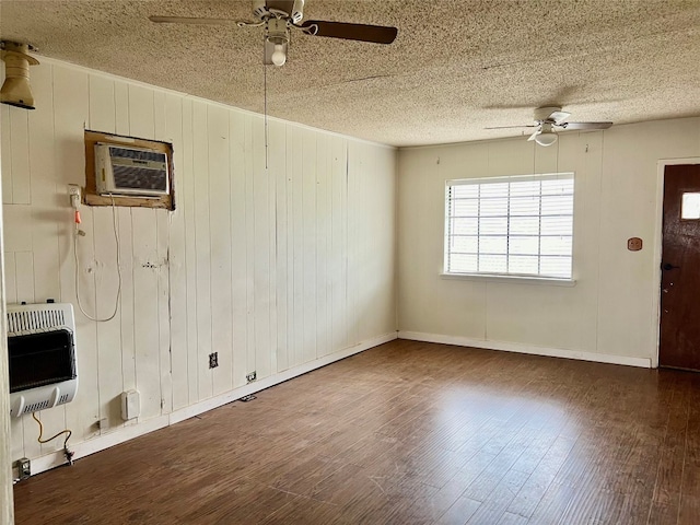 empty room featuring dark hardwood / wood-style flooring, ceiling fan, a textured ceiling, and an AC wall unit