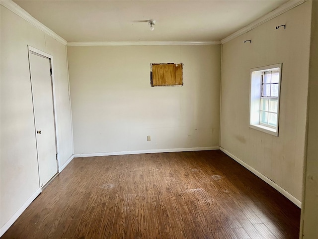 spare room with dark hardwood / wood-style flooring and ornamental molding