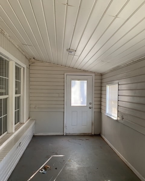 unfurnished sunroom with vaulted ceiling