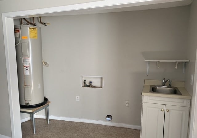 laundry room with cabinets, sink, electric dryer hookup, washer hookup, and water heater