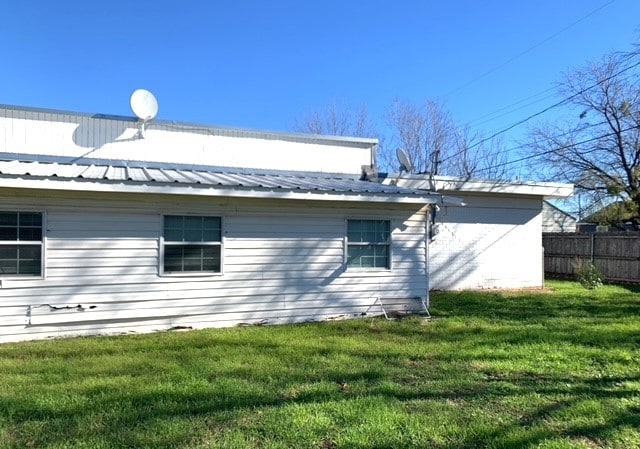 view of property exterior with a lawn