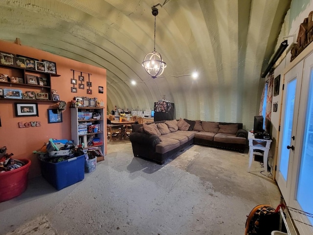 living room with a notable chandelier and lofted ceiling