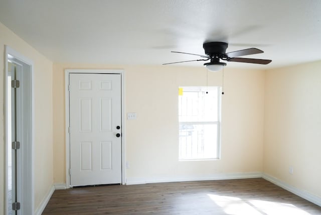 unfurnished room featuring ceiling fan and dark hardwood / wood-style floors