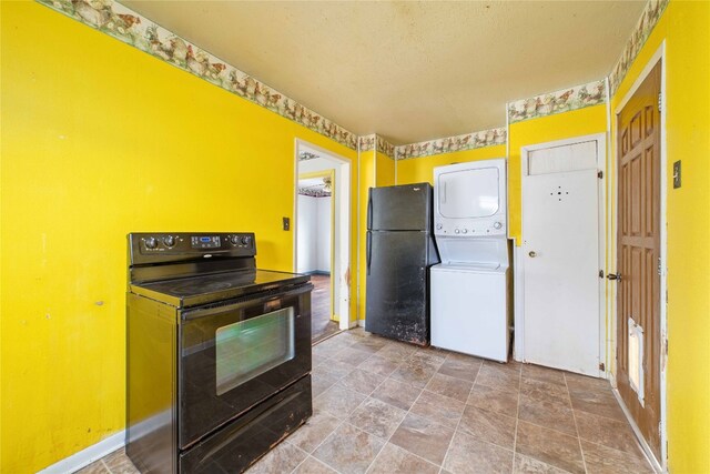 kitchen featuring light tile flooring, black appliances, and stacked washer and dryer