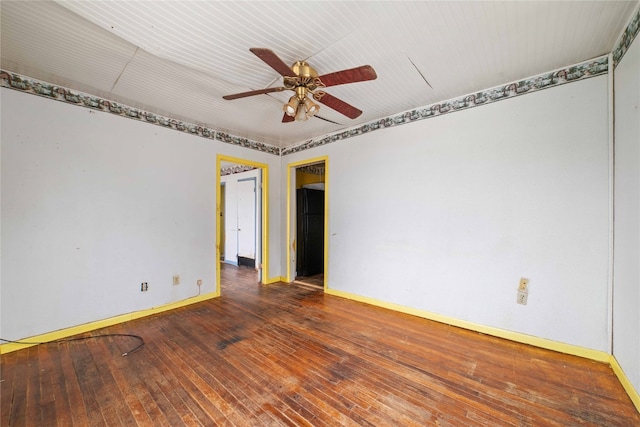 unfurnished room with dark hardwood / wood-style floors and ceiling fan