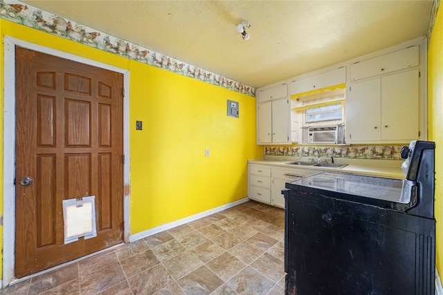 kitchen with light tile floors, white cabinetry, and sink