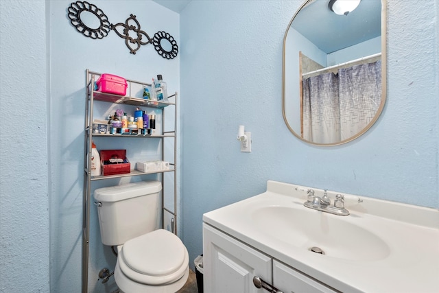 bathroom featuring toilet and vanity