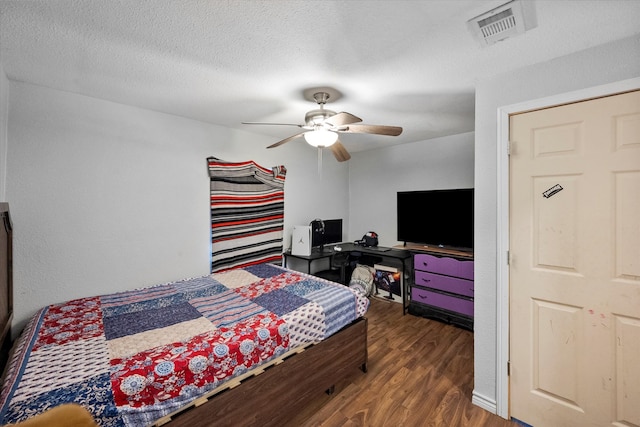 bedroom featuring a textured ceiling, ceiling fan, and dark hardwood / wood-style floors