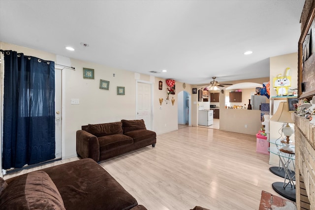 living room featuring ceiling fan and light hardwood / wood-style floors