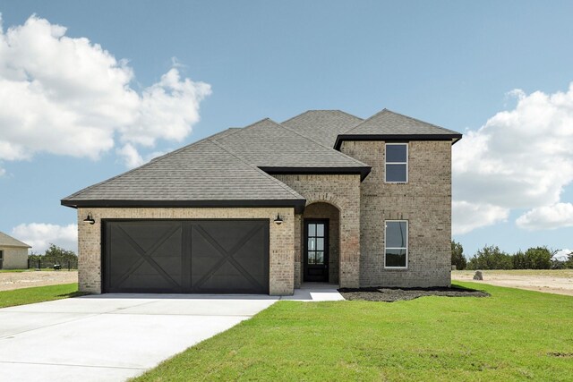 view of front of home with a garage and a front yard