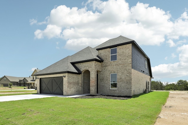 french country style house with a garage and a front lawn