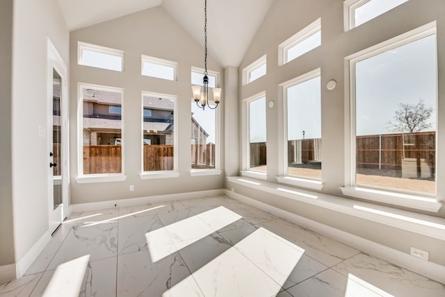 sunroom / solarium featuring a chandelier and lofted ceiling