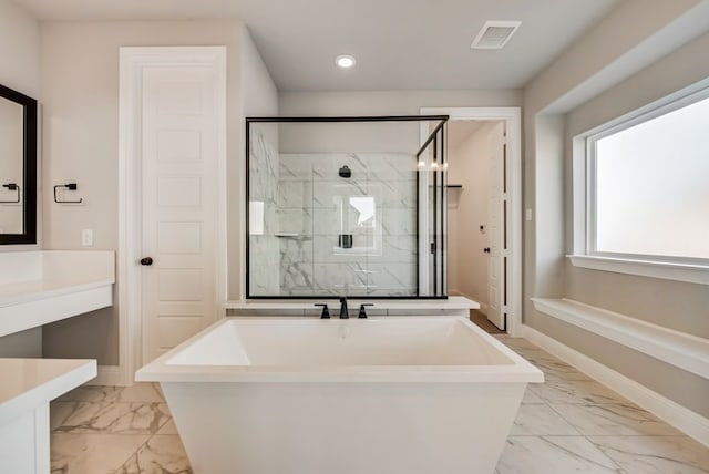 bathroom featuring a marble finish shower, baseboards, visible vents, marble finish floor, and a freestanding bath