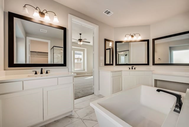 bathroom featuring marble finish floor, visible vents, two vanities, and a sink