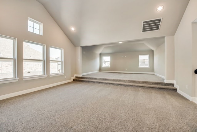 carpeted spare room with high vaulted ceiling, recessed lighting, visible vents, and baseboards