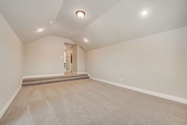 bonus room featuring visible vents, vaulted ceiling, and baseboards