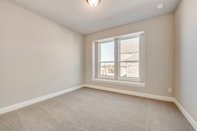 spare room with carpet flooring and baseboards