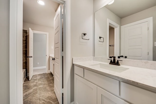 bathroom with baseboards and vanity