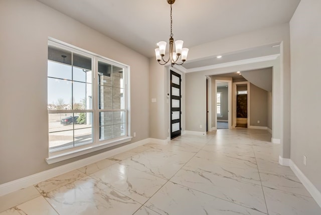 unfurnished room with marble finish floor, baseboards, and an inviting chandelier