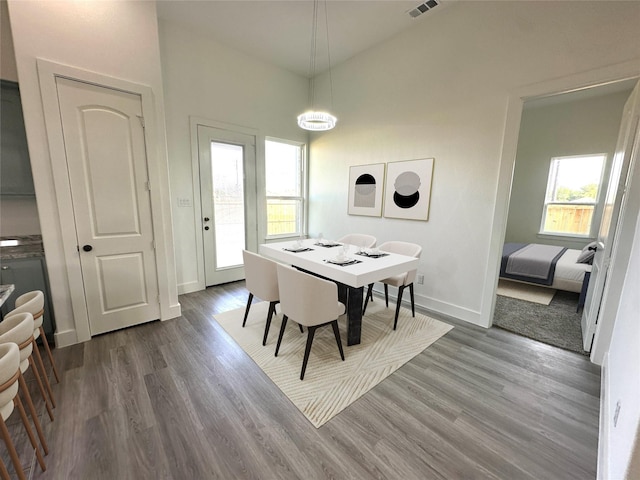 dining space with wood-type flooring