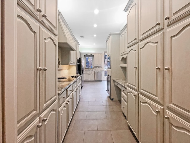 kitchen featuring backsplash, tile floors, stainless steel appliances, and light stone countertops