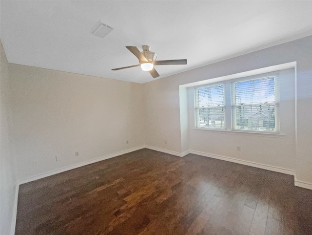 unfurnished room featuring ceiling fan and dark hardwood / wood-style floors