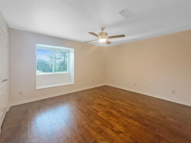 empty room featuring dark wood-type flooring and ceiling fan