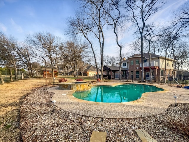 view of swimming pool featuring a patio and an in ground hot tub