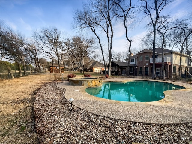 view of swimming pool featuring a patio and an in ground hot tub