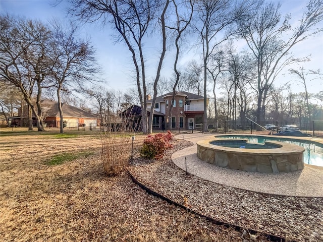 view of home's community featuring a swimming pool with hot tub