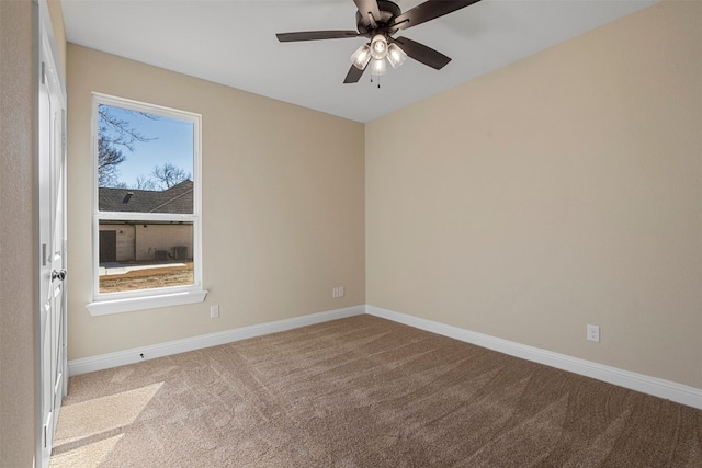 carpeted spare room featuring ceiling fan