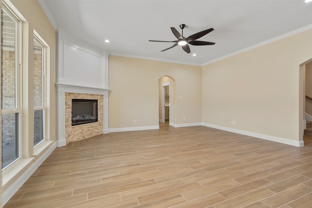 unfurnished living room with ceiling fan, crown molding, and light wood-type flooring