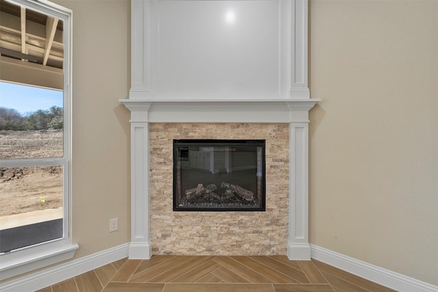 room details featuring light parquet floors and a fireplace