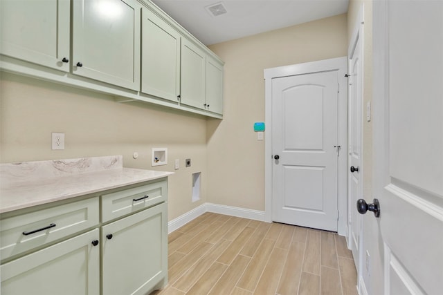 laundry area featuring cabinets, hookup for an electric dryer, light hardwood / wood-style floors, and hookup for a washing machine