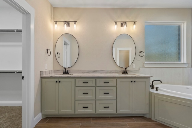 bathroom with double vanity and a bath