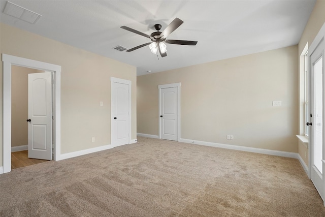 unfurnished bedroom with ceiling fan and light carpet