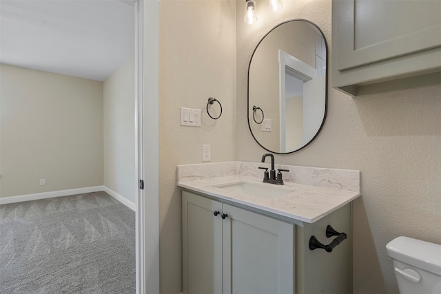 bathroom featuring toilet and vanity