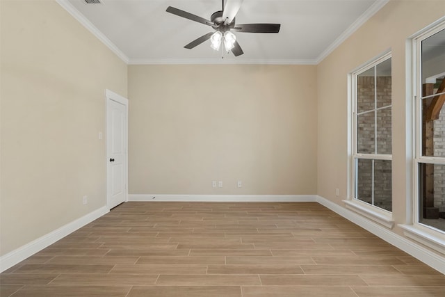 spare room featuring ceiling fan and crown molding