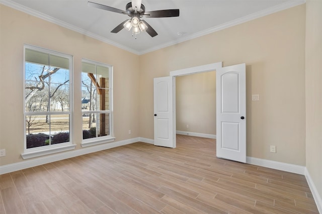 unfurnished room with ceiling fan, light hardwood / wood-style flooring, and ornamental molding