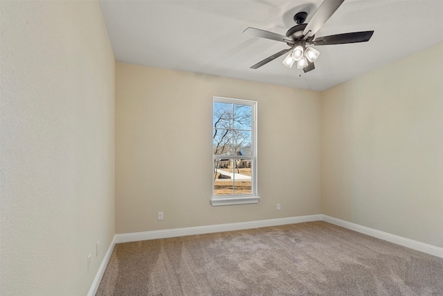 carpeted spare room featuring ceiling fan