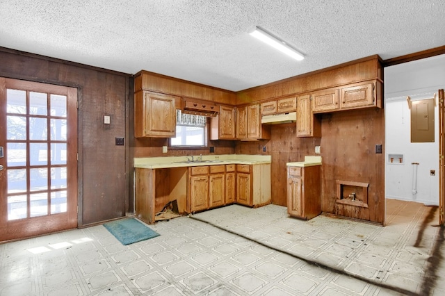 kitchen featuring a textured ceiling, sink, and light tile floors