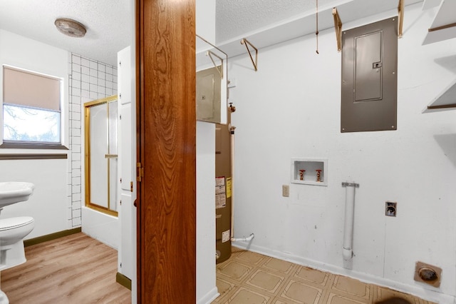 laundry room featuring a textured ceiling, electric dryer hookup, washer hookup, and light hardwood / wood-style floors