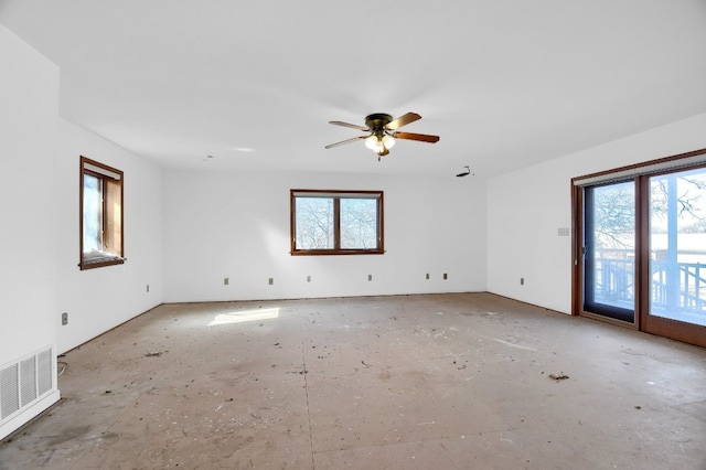 empty room featuring ceiling fan and a healthy amount of sunlight