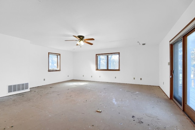 unfurnished room featuring ceiling fan and plenty of natural light